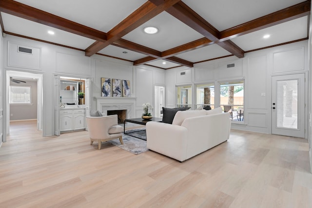 6104 Bluff Point Dr, Dallas, TX 75248 - living area with a decorative wall, beam ceiling, light wood-style flooring, a fireplace, and coffered ceiling