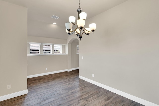 350 Windsor St, Waxahachie, TX 75165 - spare room featuring arched walkways, a chandelier, wood finished floors, and lofted ceiling