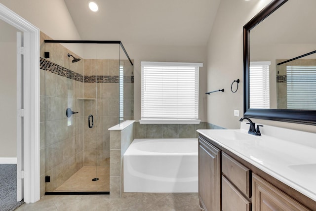 350 Windsor St, Waxahachie, TX 75165 - full bathroom featuring lofted ceiling, a bath, a shower stall, double vanity, and tile patterned flooring