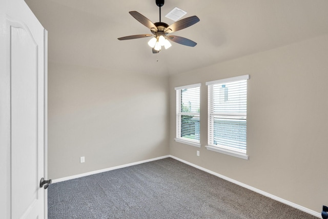 350 Windsor St, Waxahachie, TX 75165 - empty room with dark colored carpet and a ceiling fan
