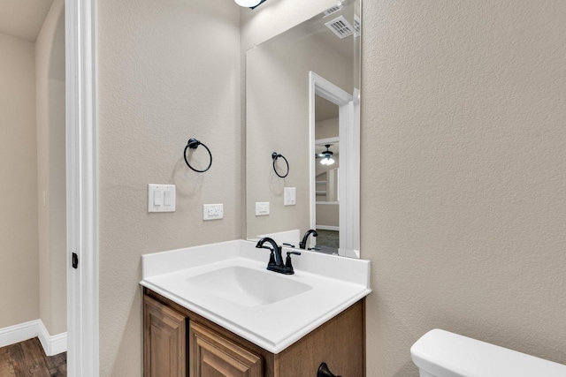 350 Windsor St, Waxahachie, TX 75165 - half bathroom with vanity, wood finished floors, and a textured wall