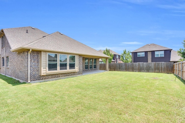 350 Windsor St, Waxahachie, TX 75165 - back of property featuring brick siding, roof with shingles, a fenced backyard, and a patio