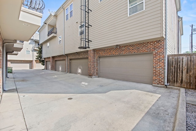 3200 Ross Ave Unit 22, Dallas, TX 75204 - view of side of home featuring brick siding, driveway, and an attached garage