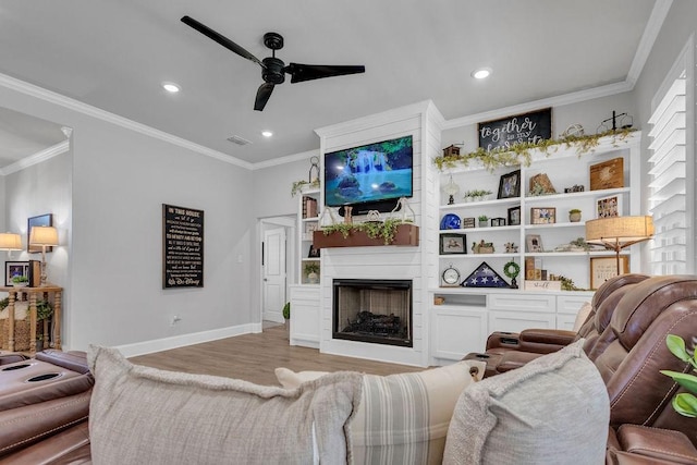 14423 Woodland Crk, Tyler, TX 75706 - living area featuring a ceiling fan, wood finished floors, a fireplace, recessed lighting, and crown molding