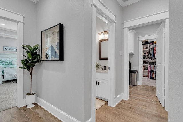 14423 Woodland Crk, Tyler, TX 75706 - hallway with light wood-style flooring and ornamental molding