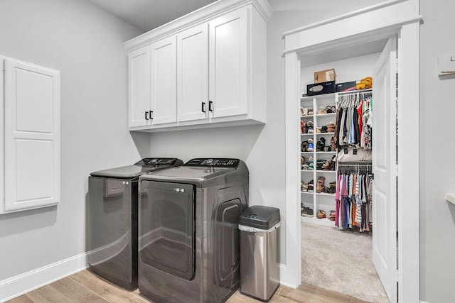 14423 Woodland Crk, Tyler, TX 75706 - laundry room with separate washer and dryer, cabinet space, and light wood finished floors