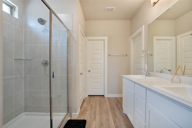 367 Oak Creek Dr, Lavon, TX 75166 - bathroom featuring a shower stall, double vanity, and wood finished floors