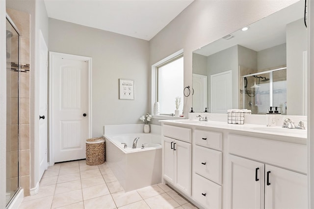 1117 Lake Woodland Dr, Little Elm, TX 75068 - bathroom featuring a shower stall, double vanity, a bath, and tile patterned floors