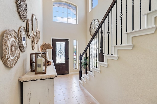 1117 Lake Woodland Dr, Little Elm, TX 75068 - entrance foyer with light tile patterned floors, plenty of natural light, stairs, and a towering ceiling