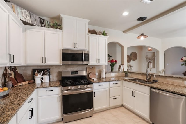 1117 Lake Woodland Dr, Little Elm, TX 75068 - kitchen featuring stainless steel appliances, tasteful backsplash, white cabinetry, dark stone countertops, and beam ceiling