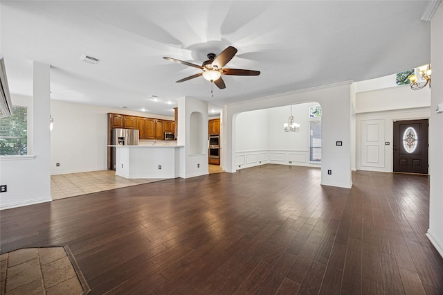 3403 Brighton Ct, Highland Village, TX 75077 - unfurnished living room with arched walkways, ceiling fan, hardwood / wood-style flooring, and a chandelier