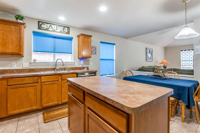 113 Cayman Dr, Lancaster, TX 75146 - kitchen with light tile patterned floors, a kitchen island, open floor plan, brown cabinets, and recessed lighting