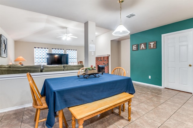 113 Cayman Dr, Lancaster, TX 75146 - dining room featuring light tile patterned floors, ceiling fan, and a brick fireplace