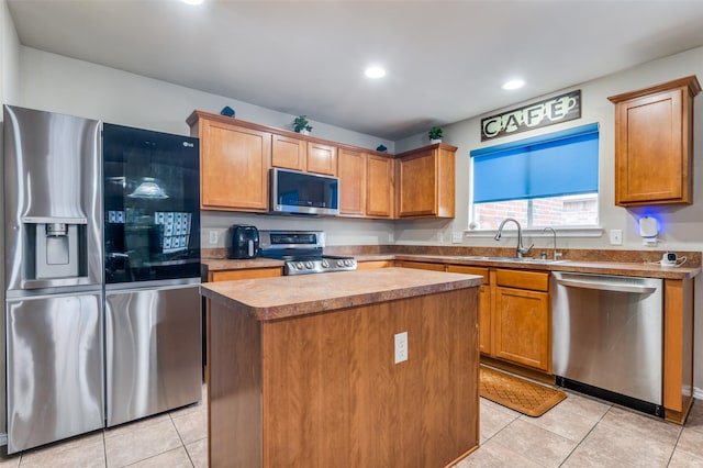 113 Cayman Dr, Lancaster, TX 75146 - kitchen with stainless steel appliances, light tile patterned flooring, a center island, recessed lighting, and brown cabinetry