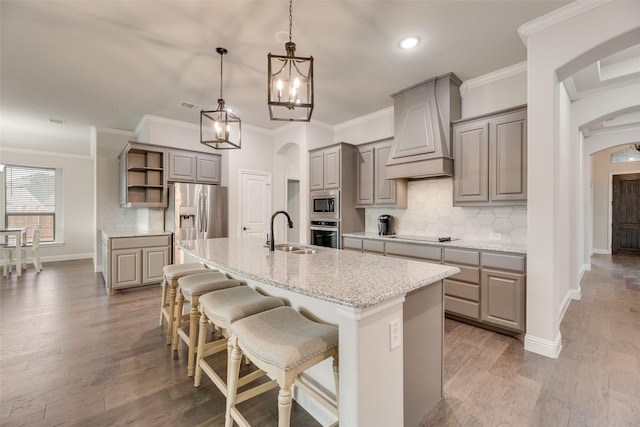 629 Dean Box Dr, Waxahachie, TX 75165 - kitchen featuring gray cabinetry, stainless steel appliances, arched walkways, open shelves, and an island with sink
