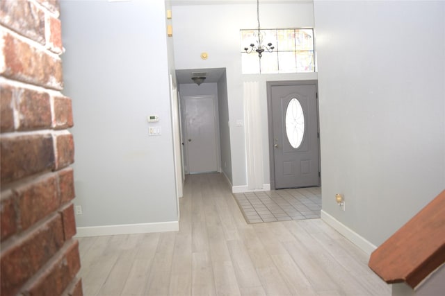 803 Ashmount Ln, Arlington, TX 76017 - entrance foyer featuring light wood-type flooring, a chandelier, and a towering ceiling