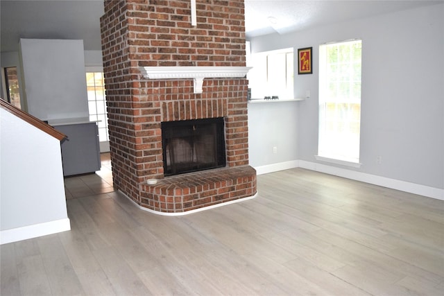 803 Ashmount Ln, Arlington, TX 76017 - unfurnished living room featuring wood finished floors and a fireplace