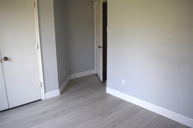 803 Ashmount Ln, Arlington, TX 76017 - unfurnished bedroom featuring light wood-style flooring and baseboards