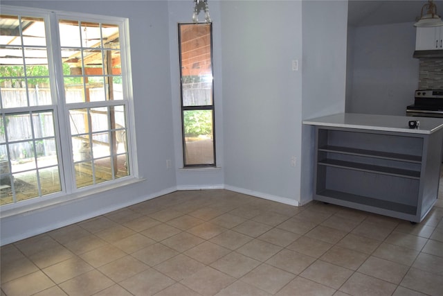 803 Ashmount Ln, Arlington, TX 76017 - unfurnished dining area with light tile patterned flooring and baseboards