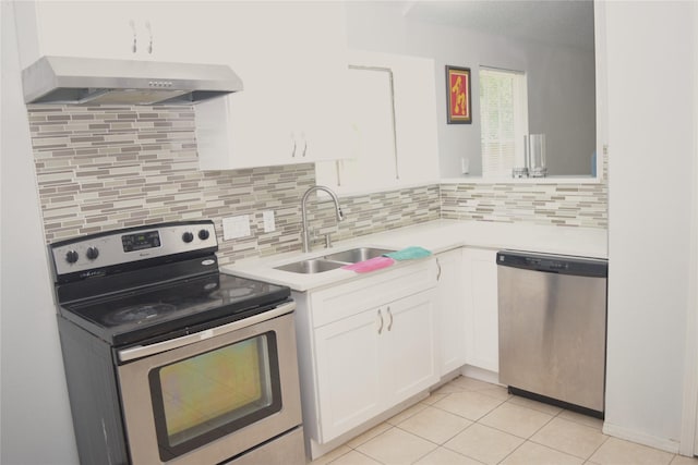 803 Ashmount Ln, Arlington, TX 76017 - kitchen with stainless steel appliances, exhaust hood, light countertops, and white cabinetry