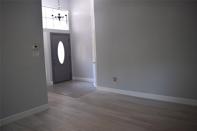 803 Ashmount Ln, Arlington, TX 76017 - entryway with a chandelier, wood finished floors, and a high ceiling