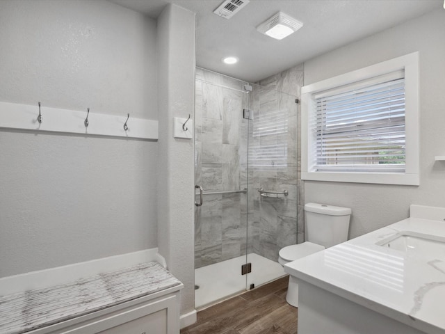 1704 Charlottesville Dr, Ennis, TX 75119 - full bath featuring a stall shower, vanity, and wood finished floors