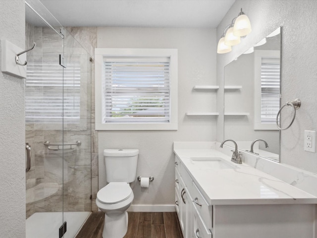 1704 Charlottesville Dr, Ennis, TX 75119 - bathroom featuring vanity, wood finished floors, and a stall shower