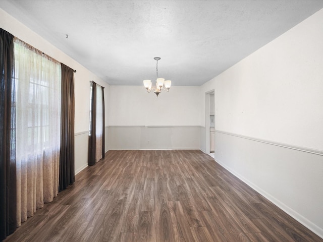 1704 Charlottesville Dr, Ennis, TX 75119 - unfurnished dining area featuring a chandelier and dark wood-style flooring