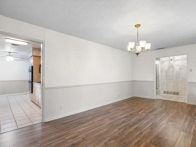 1704 Charlottesville Dr, Ennis, TX 75119 - empty room featuring a chandelier, wood finished floors, and ceiling fan