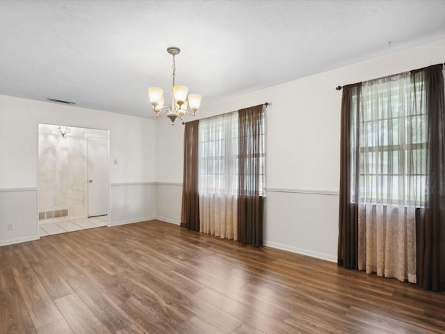 1704 Charlottesville Dr, Ennis, TX 75119 - spare room featuring a chandelier and wood finished floors