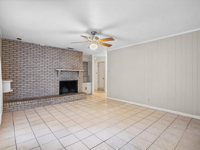 1704 Charlottesville Dr, Ennis, TX 75119 - unfurnished living room featuring a ceiling fan, a fireplace, brick wall, and light tile patterned flooring