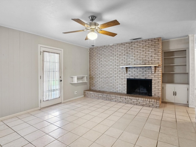 1704 Charlottesville Dr, Ennis, TX 75119 - unfurnished living room featuring ornamental molding, ceiling fan, tile patterned flooring, and a brick fireplace