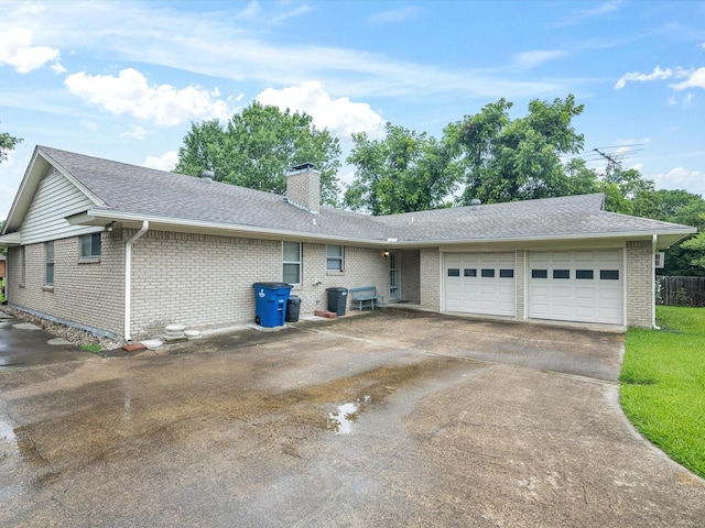 1704 Charlottesville Dr, Ennis, TX 75119 - view of front facade with a garage, brick siding, a chimney, concrete driveway, and a shingled roof