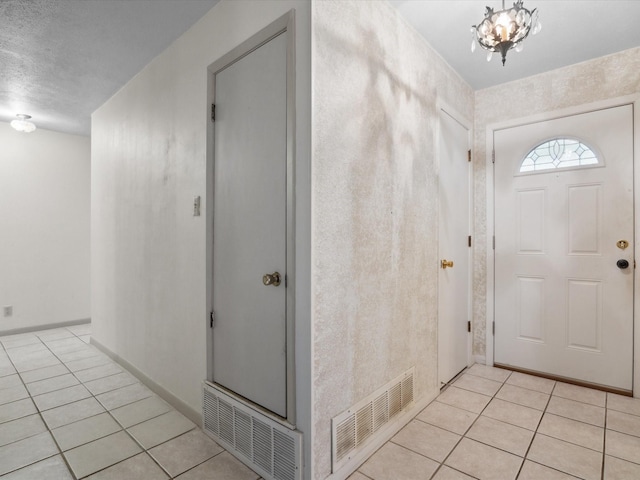 1704 Charlottesville Dr, Ennis, TX 75119 - entrance foyer featuring light tile patterned floors and a chandelier