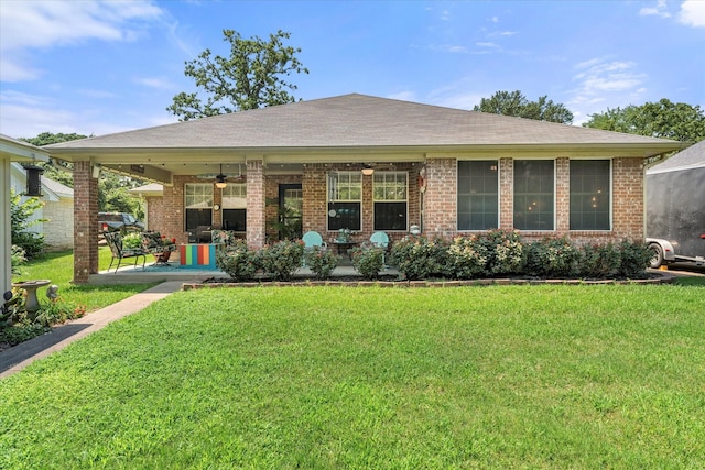 152 Guadalupe Dr, Gun Barrel City, TX 75156 - view of front facade with a ceiling fan, a front yard, brick siding, and covered porch