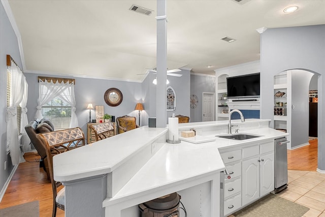 152 Guadalupe Dr, Gun Barrel City, TX 75156 - kitchen with open floor plan, ornamental molding, arched walkways, ceiling fan, and light countertops