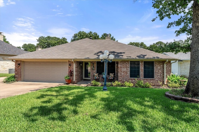 152 Guadalupe Dr, Gun Barrel City, TX 75156 - ranch-style home with an attached garage, concrete driveway, a chimney, a front yard, and brick siding