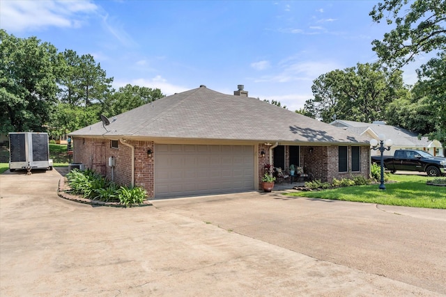 152 Guadalupe Dr, Gun Barrel City, TX 75156 - ranch-style home with brick siding, a garage, concrete driveway, a chimney, and a front lawn