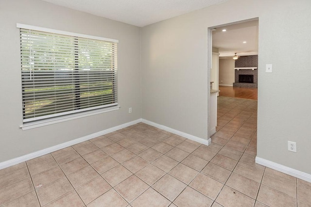 1804 Briarpath Ln, Arlington, TX 76018 - spare room featuring light tile patterned floors, a ceiling fan, recessed lighting, and a fireplace