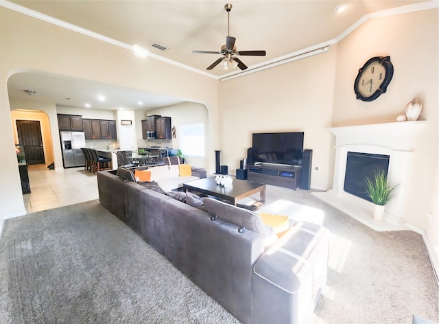3812 Gennaker Dr, Denton, TX 76210 - living area with arched walkways, crown molding, a glass covered fireplace, a ceiling fan, and recessed lighting