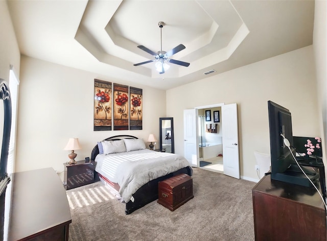 3812 Gennaker Dr, Denton, TX 76210 - carpeted bedroom with a raised ceiling, ensuite bathroom, and ceiling fan