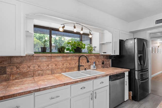 4925 Terrace Trl, Fort Worth, TX 76114 - kitchen featuring appliances with stainless steel finishes, white cabinets, open shelves, decorative backsplash, and light wood-style floors