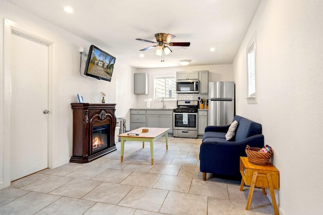 1725 Engle Ave, Dallas, TX 75224 - living area with ceiling fan, a glass covered fireplace, and light tile patterned floors