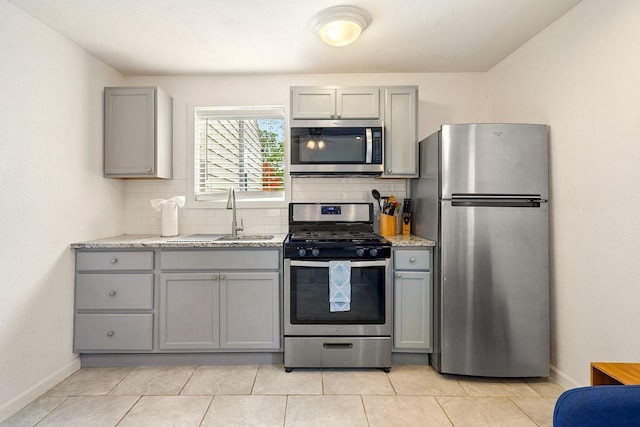 1725 Engle Ave, Dallas, TX 75224 - kitchen featuring appliances with stainless steel finishes, gray cabinets, and backsplash