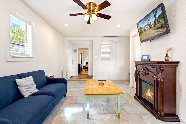 1725 Engle Ave, Dallas, TX 75224 - living area featuring radiator heating unit, a wall unit AC, a glass covered fireplace, a ceiling fan, and light tile patterned floors