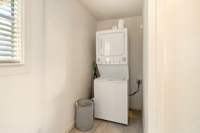 1725 Engle Ave, Dallas, TX 75224 - laundry room with stacked washer / drying machine, radiator heating unit, and light tile patterned flooring