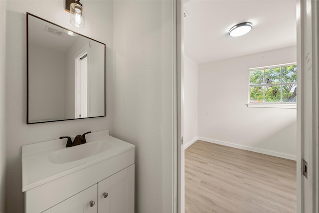 1012 W Trinity St, Groesbeck, TX 76642 - bathroom with vanity and wood finished floors