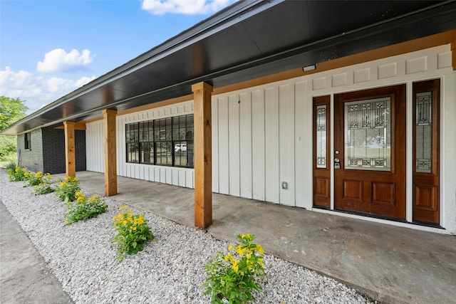 1012 W Trinity St, Groesbeck, TX 76642 - entrance to property featuring covered porch and board and batten siding