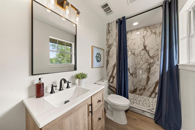1012 W Trinity St, Groesbeck, TX 76642 - bathroom with vanity, wood finished floors, and a marble finish shower