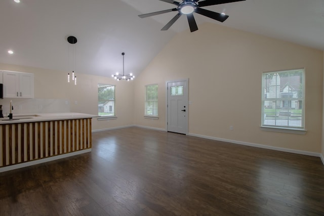 3127 Mcdermott Ave, Dallas, TX 75215 - unfurnished living room with ceiling fan, dark wood-style floors, a chandelier, high vaulted ceiling, and recessed lighting